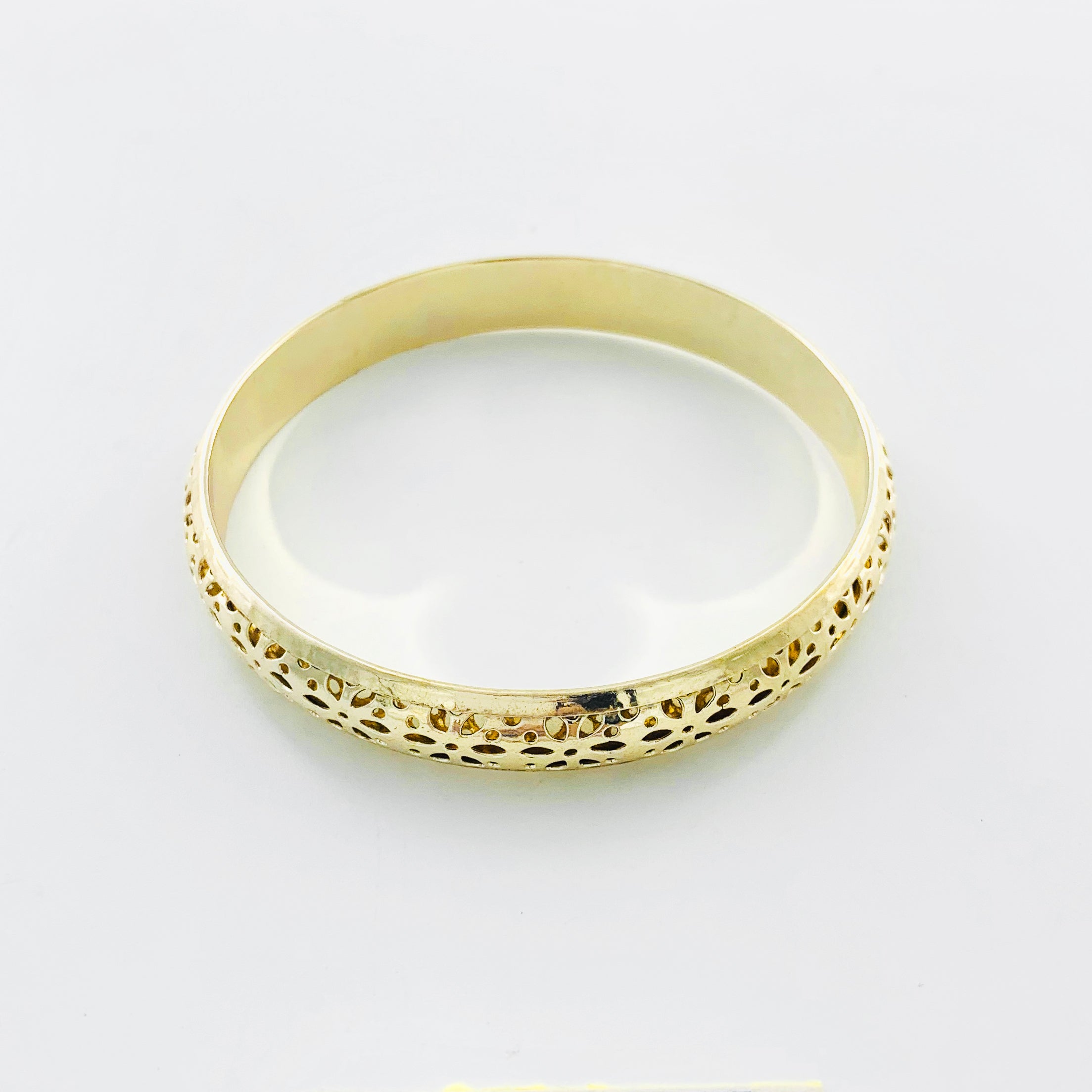 Gold bangle with floral cut-out patterns