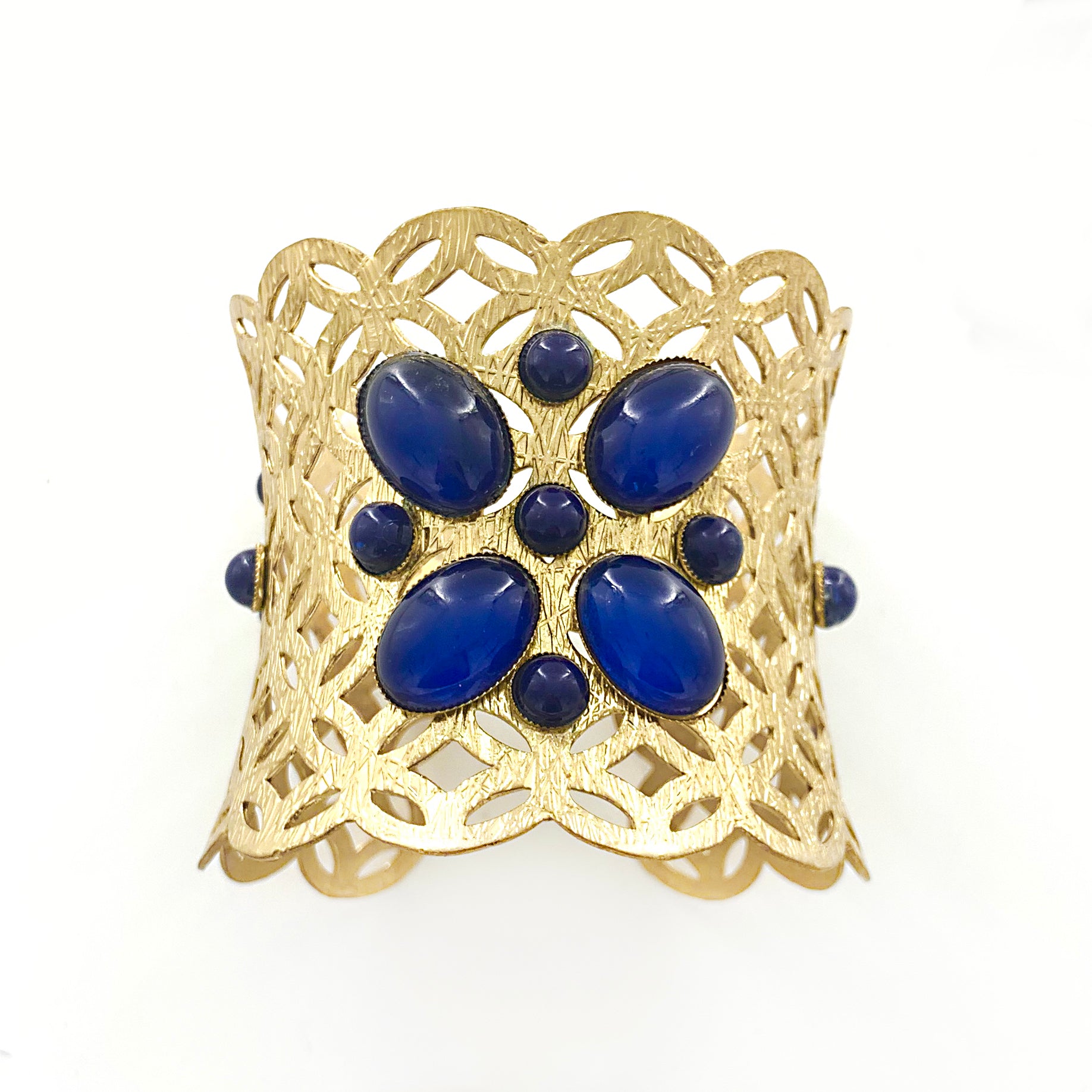 Matt gold cuff with geometric cut-outs and blue beads