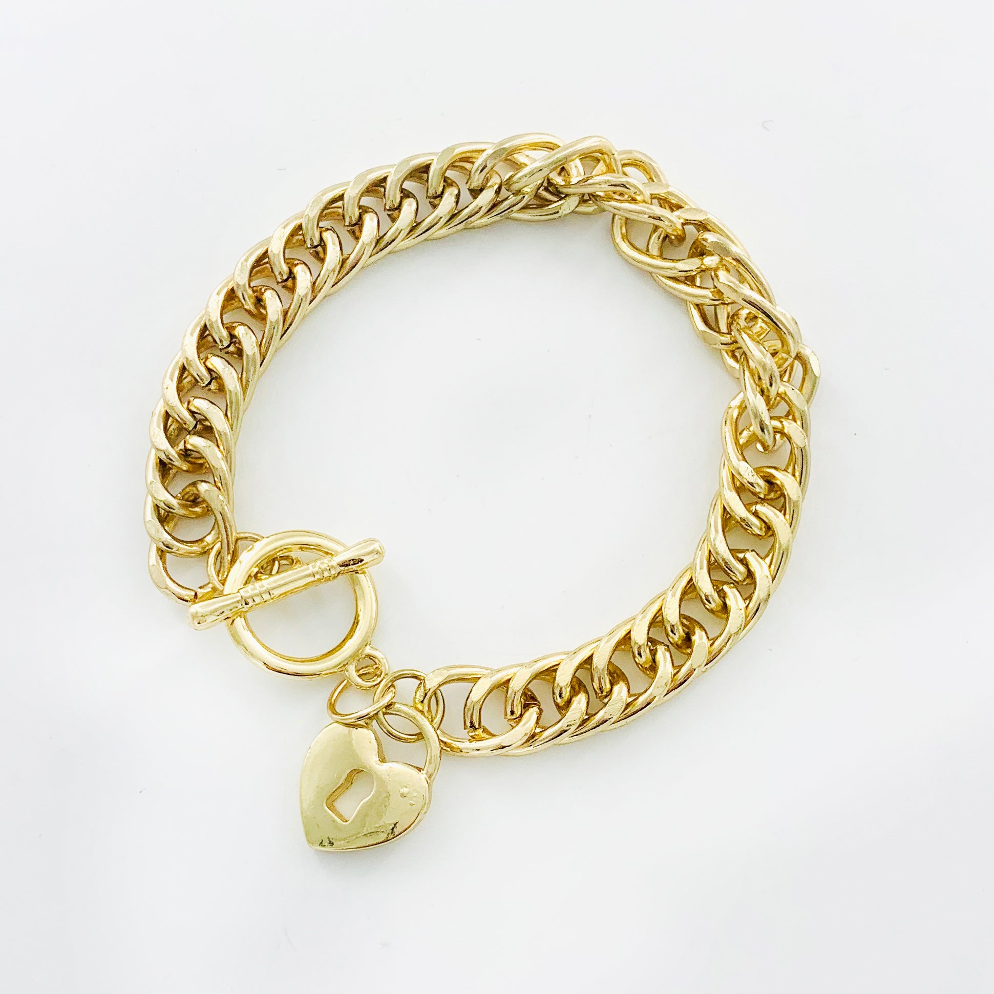 Chunky gold chain with gold heart charm