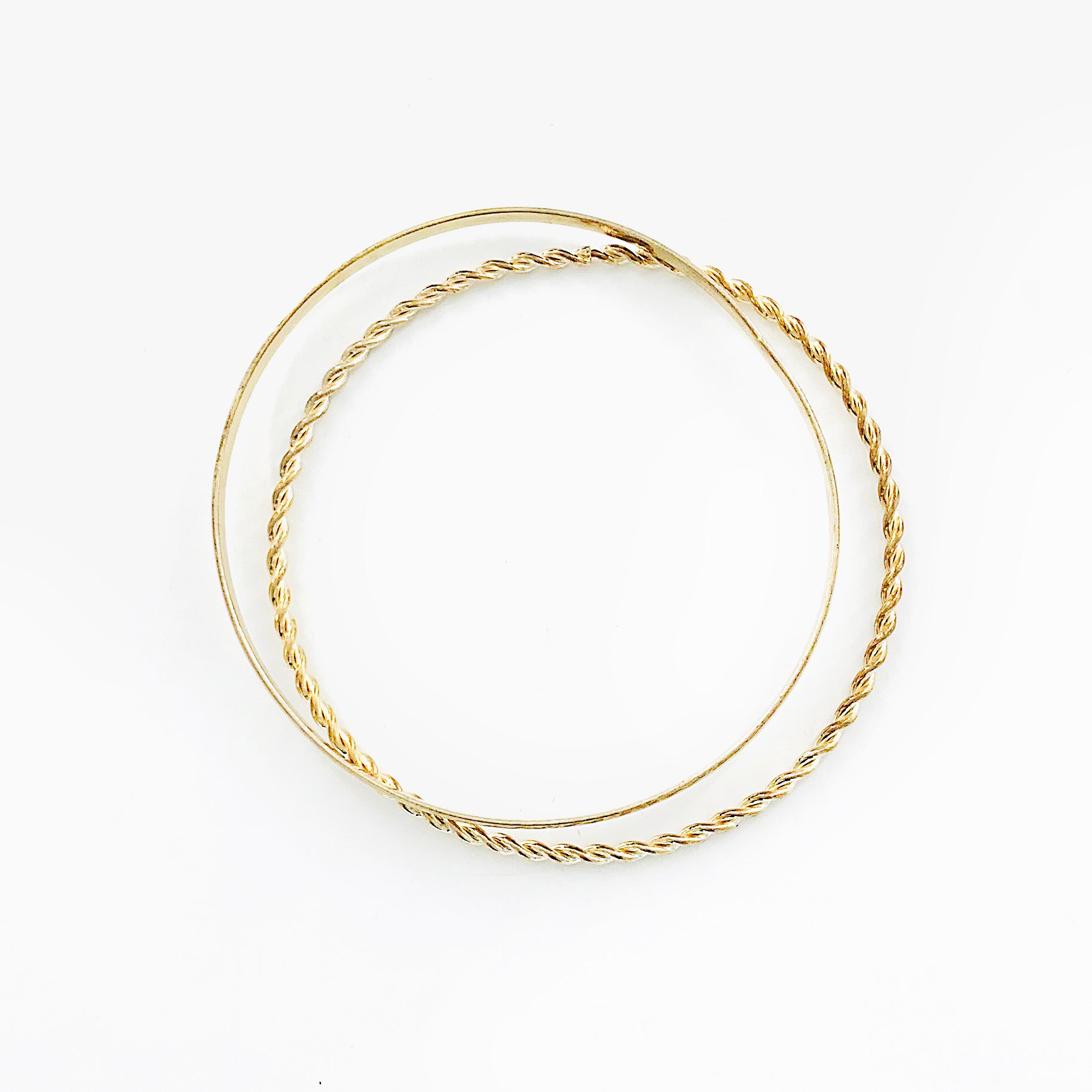 Thin gold bangles with twisted design