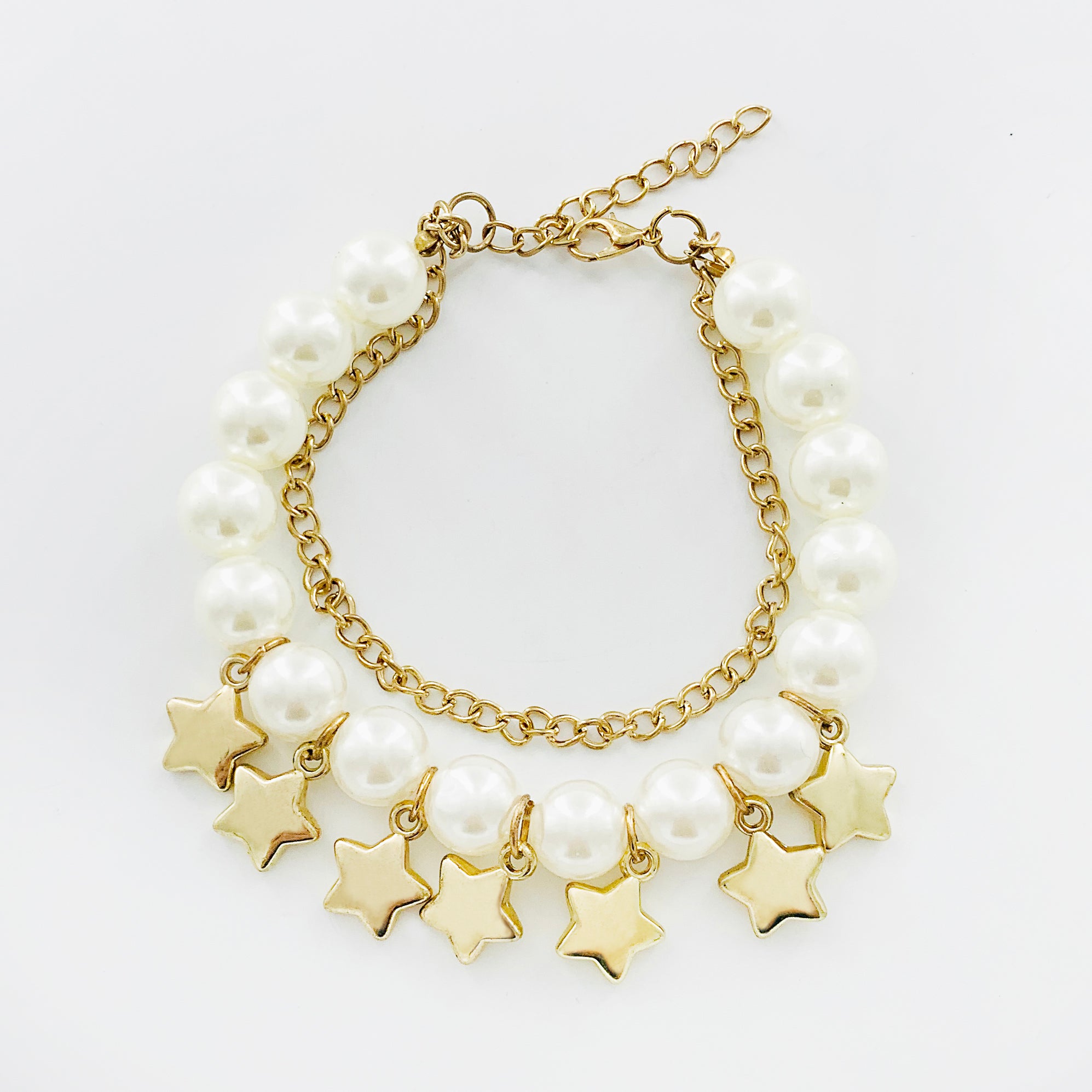 Gold and pearl bracelet with star charms
