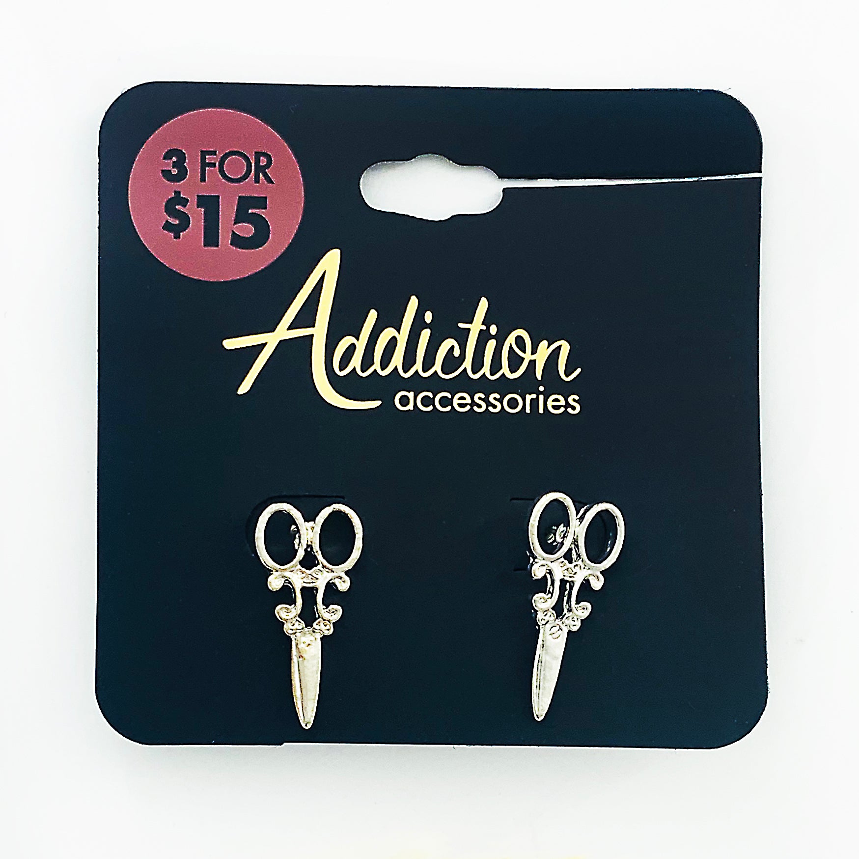 Silver earrings in an ornate scissors design