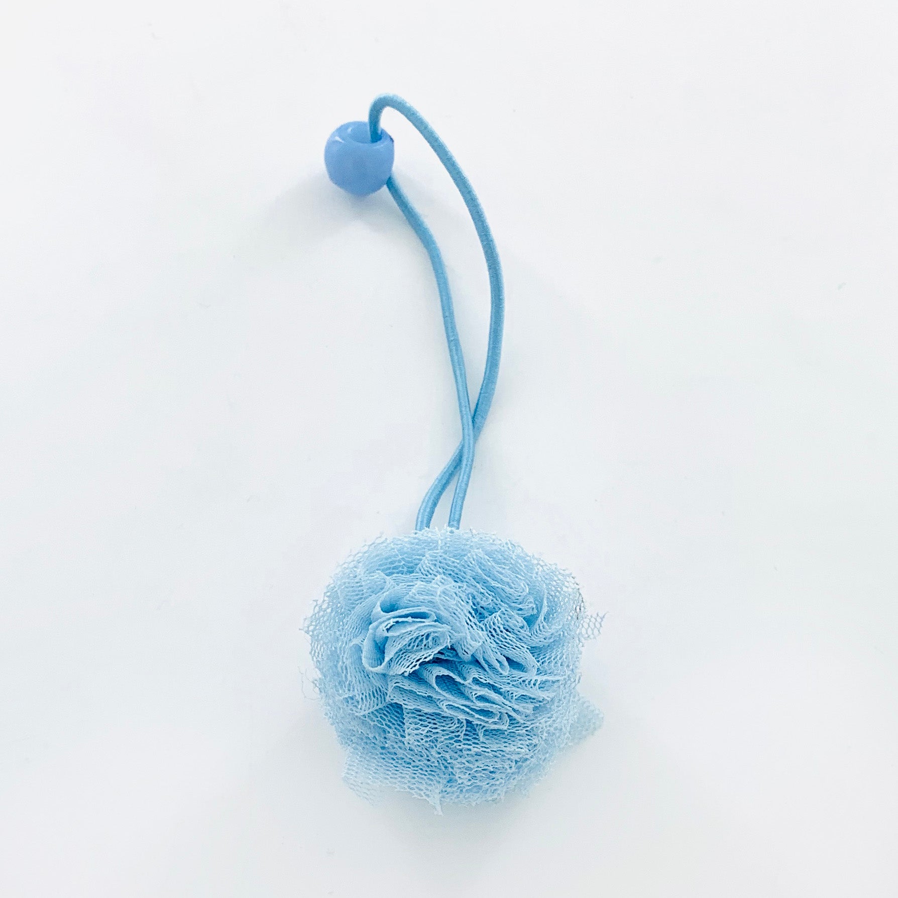 Blue rubber band with fluffy fabric pom pom