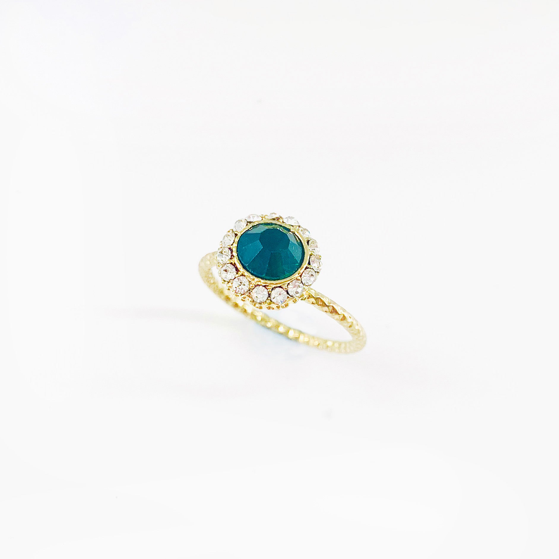 Emerald coloured crystal with diamante stones on textured gold ring