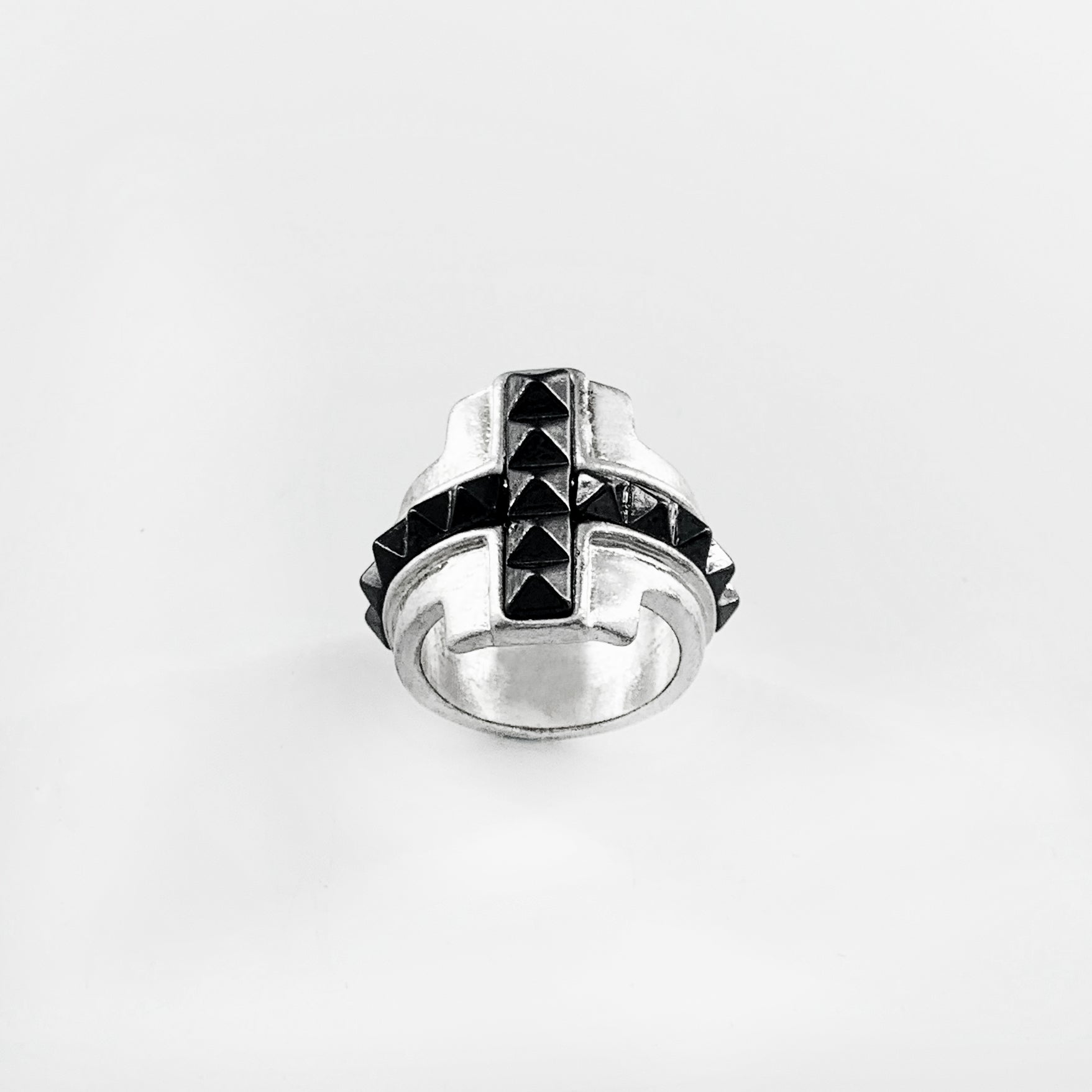 Silver ring with black studded cross